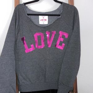 L cut neck sweat shirt.  Dark grey with fuscia sequence writing.